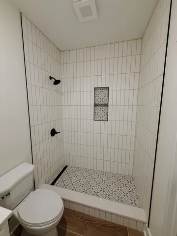 a bathroom with a toilet and shower