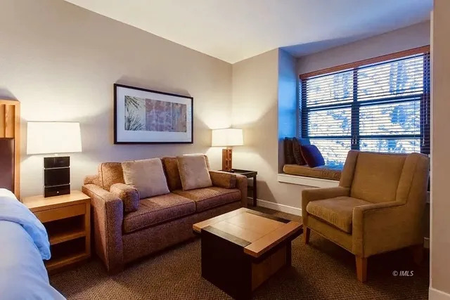 a living room with furniture and a lamp