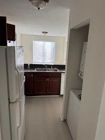 a kitchen with refrigerator and window