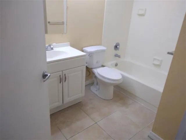 a white toilet sitting next to a bath tub