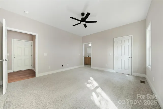 a view of a livingroom with a ceiling fan & window