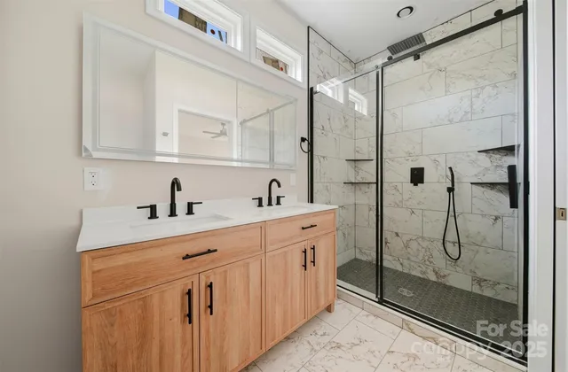 a bathroom with a shower sink and mirror