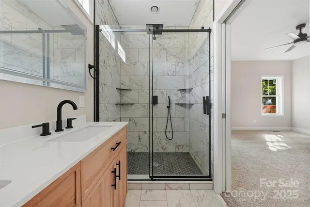 a bathroom with a double vanity sink a mirror and shower