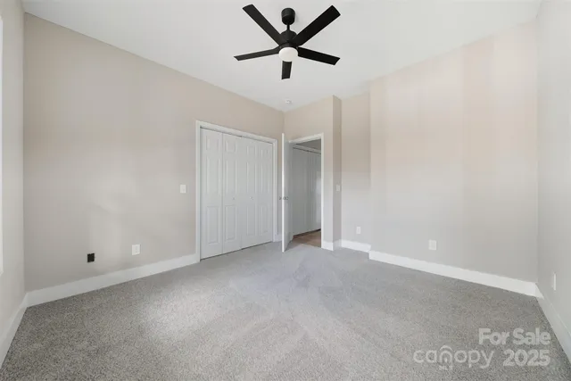 an empty room with a ceiling fan and a ceiling fan