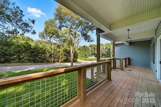 a view of balcony with wooden floor and fence