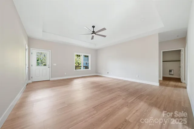 wooden floor in an empty room with a window