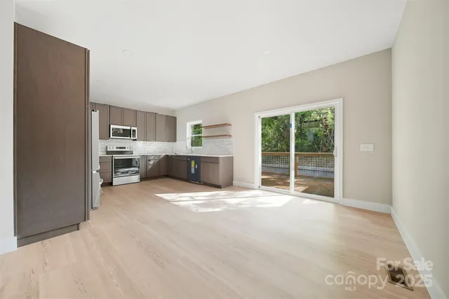 a view of a kitchen with a sink cabinets and a refrigerator