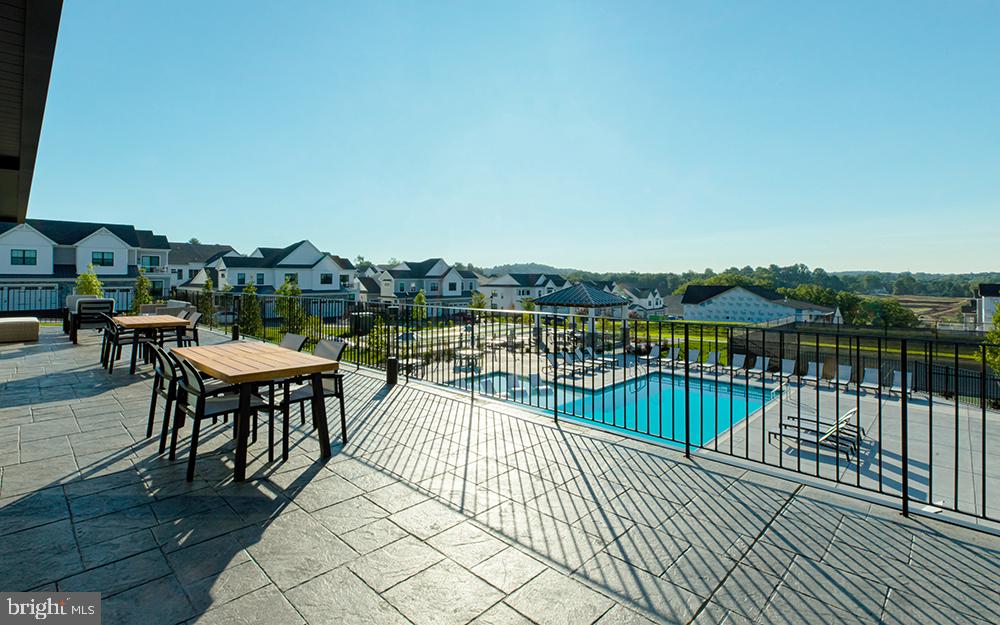 509 Trifecta Road, Unit 371 Downingtown, PA 19335 - Photo 25 of 37 a view of a chairs and table on wooden deck with a lake view