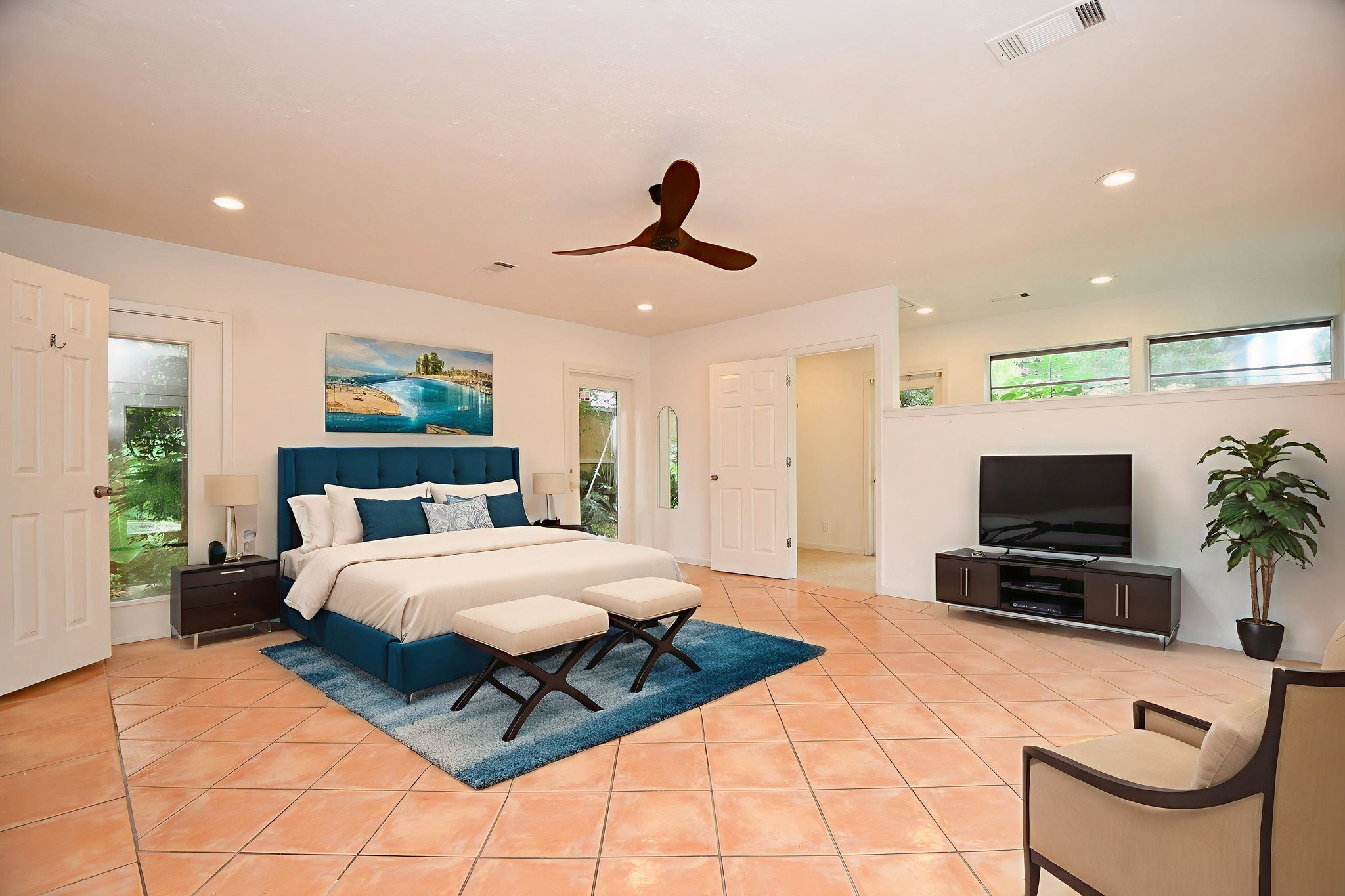 5015 Grape Street Houston, TX 77096 - Photo 13 of 28 a bedroom with a bed a couch and a flat screen tv