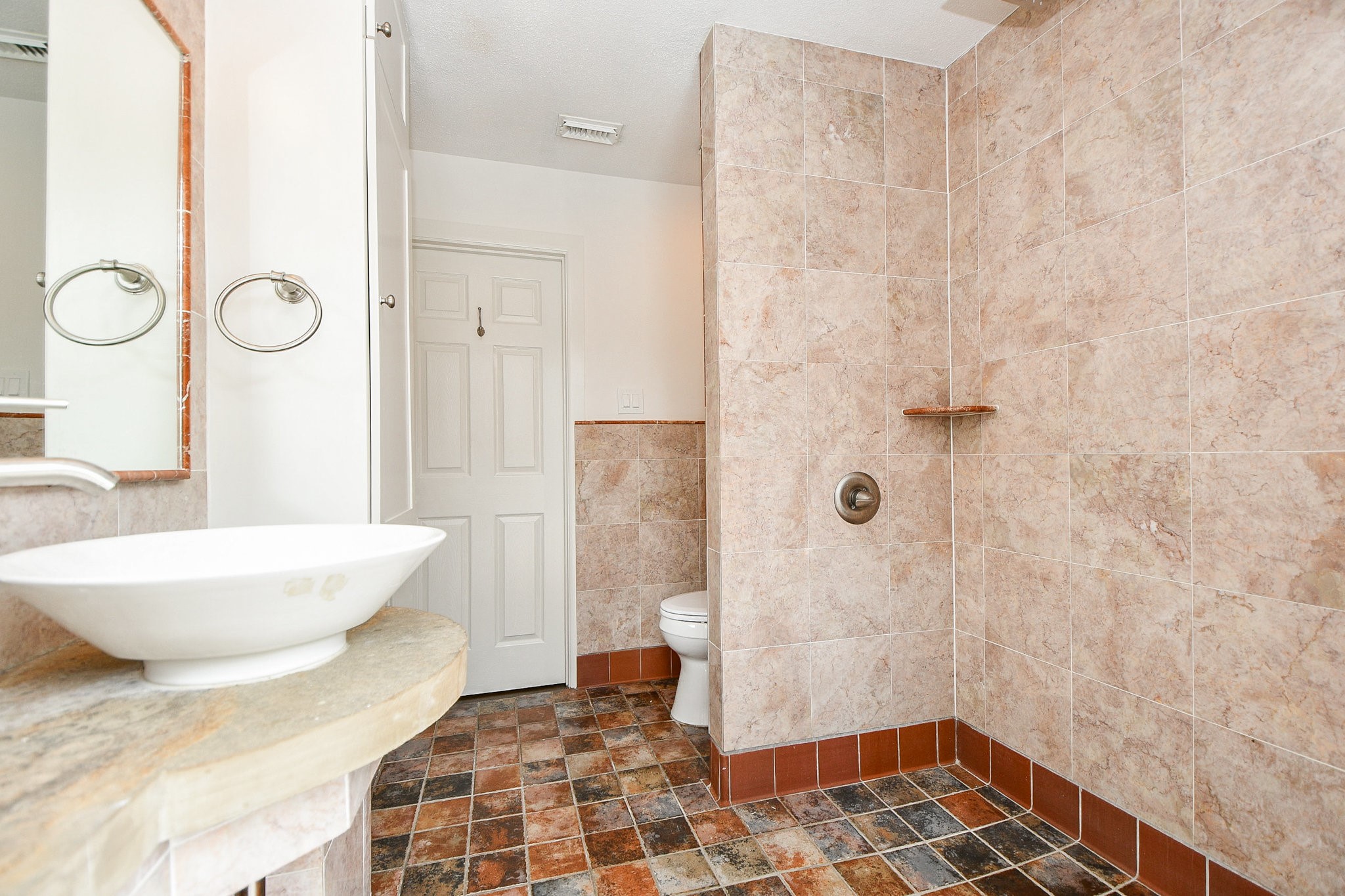 5015 Grape Street Houston, TX 77096 - Photo 17 of 28 a bathroom with a sink and a shower
