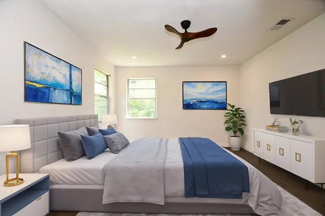 a bedroom with a bed and a flat screen tv