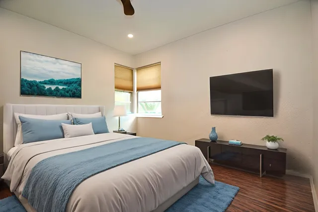 a bedroom with a bed and a flat screen tv