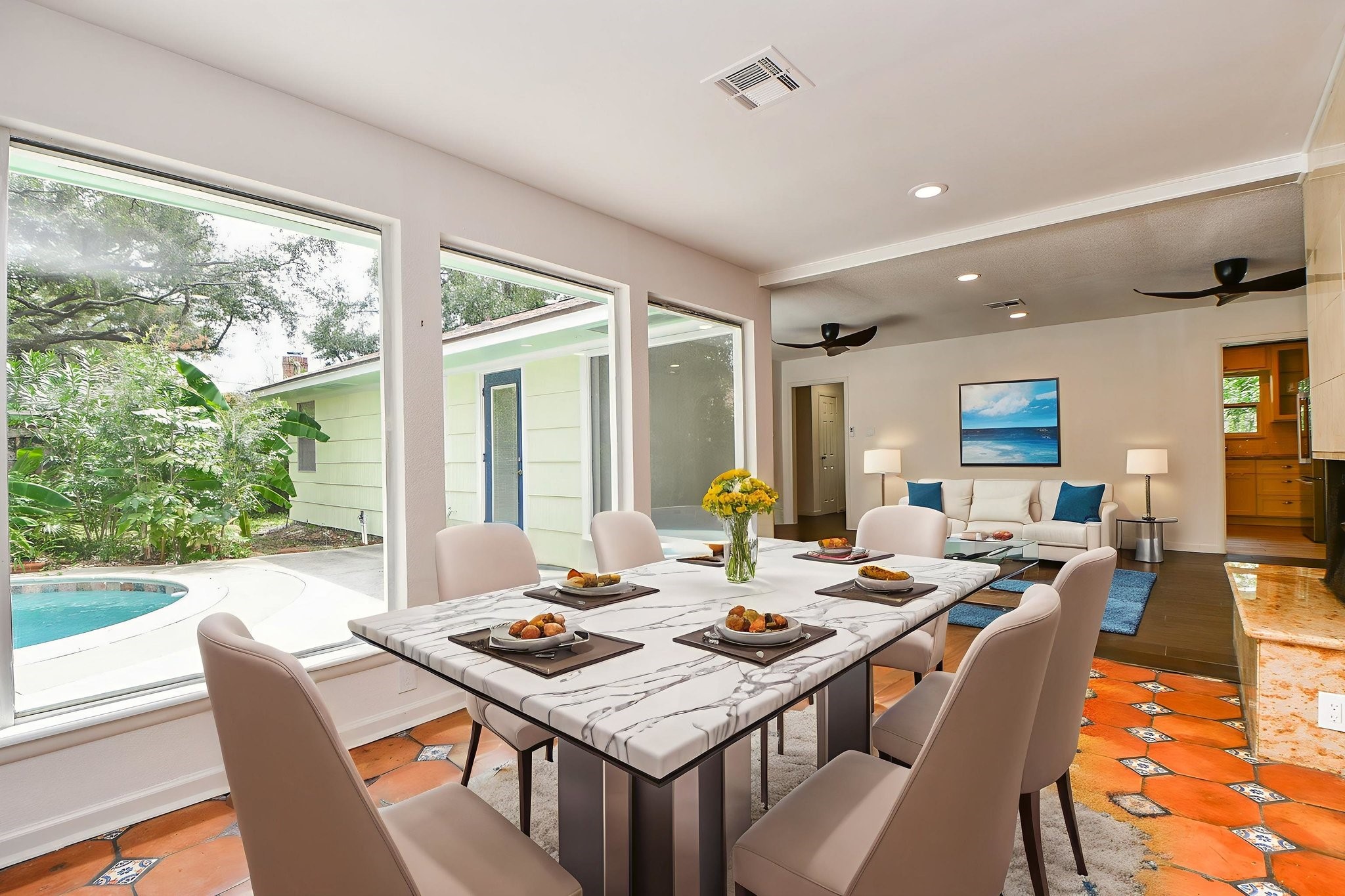 5015 Grape Street Houston, TX 77096 - Photo 4 of 28 a dining room with wooden floor a glass table and chairs