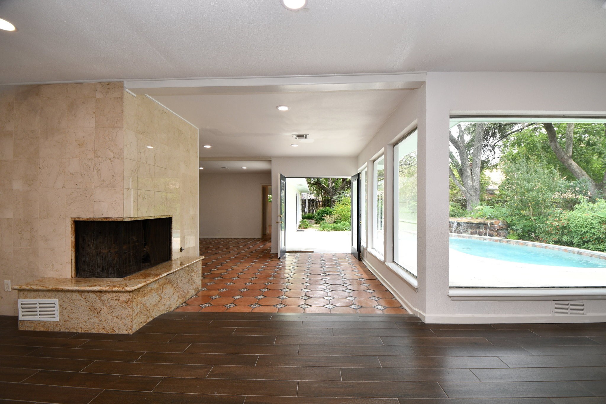 5015 Grape Street Houston, TX 77096 - Photo 5 of 28 a living room with a fireplace and wooden floor