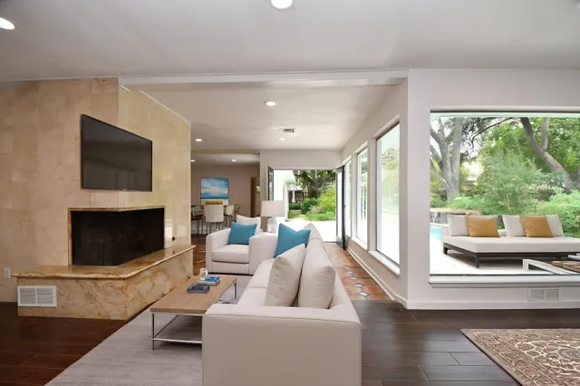 a living room with fireplace furniture and a flat screen tv