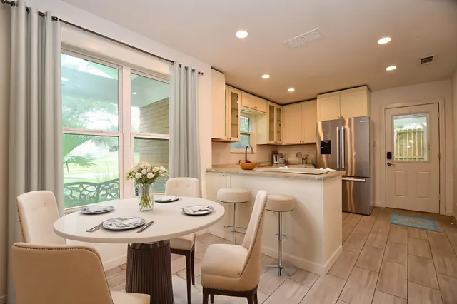 a kitchen with kitchen island granite countertop a sink and refrigerator