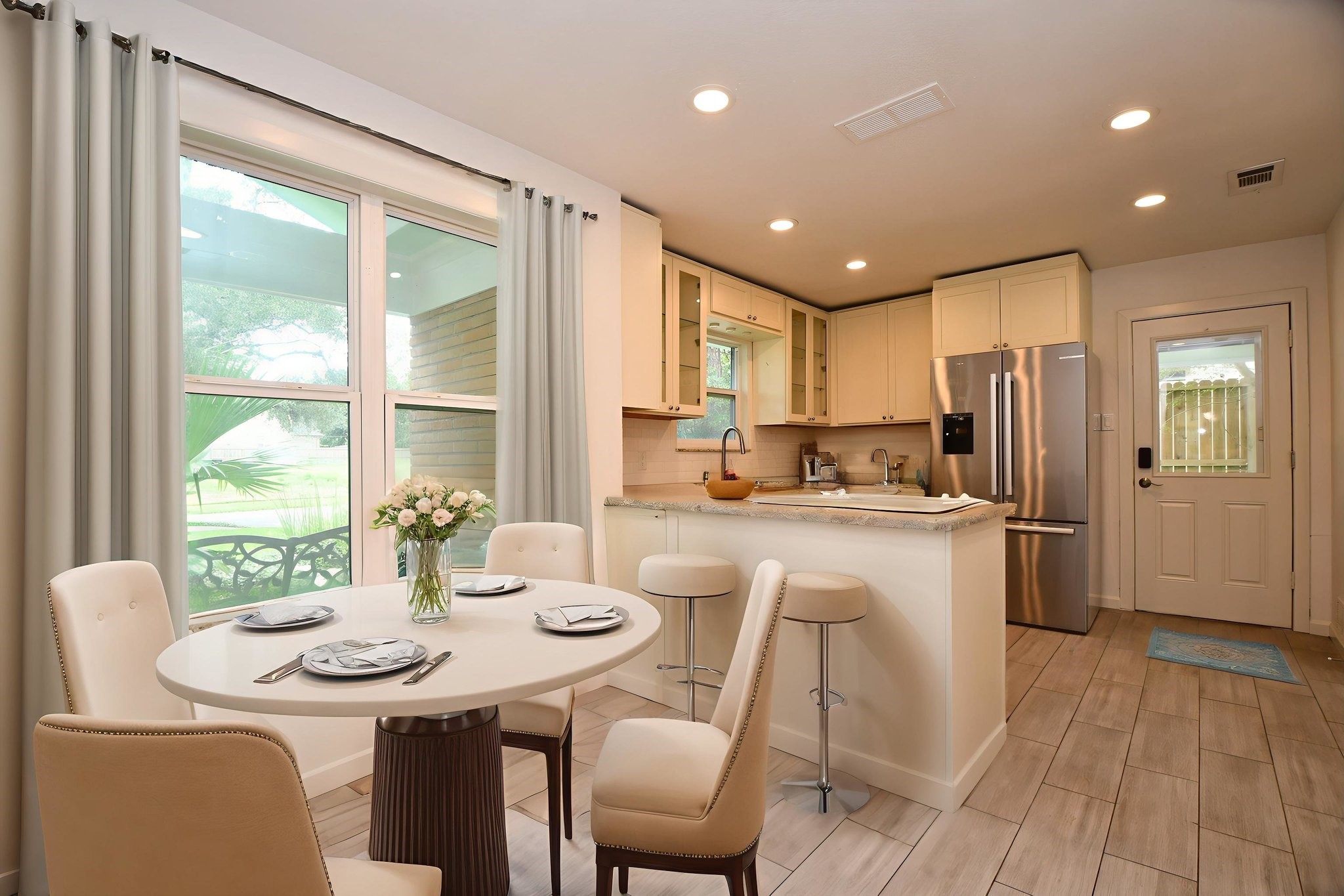 5015 Grape Street Houston, TX 77096 - Photo 10 of 28 a kitchen with kitchen island granite countertop a sink and refrigerator