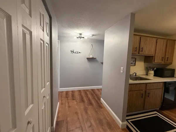 a view of a kitchen with cabinets and wooden floor
