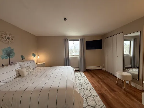 a bedroom with a bed and a potted plant