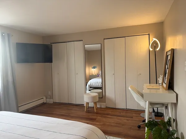 a bedroom with a bed and a potted plant