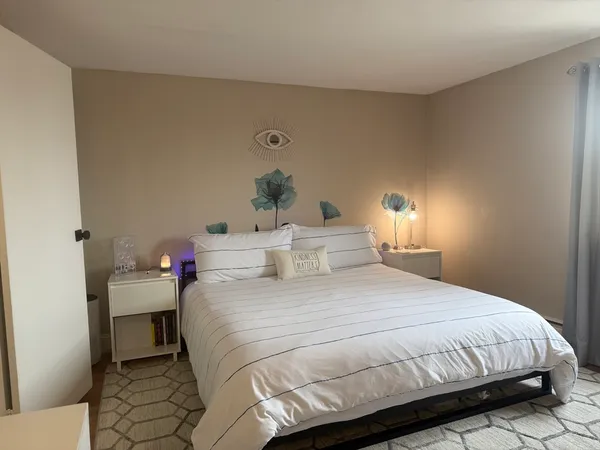 a bedroom with a bed and a lamp