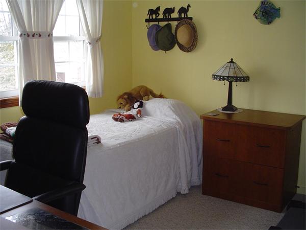 195 North Road Chelmsford, MA 01824 - Photo 11 of 17 a bedroom with a bed and a chandelier