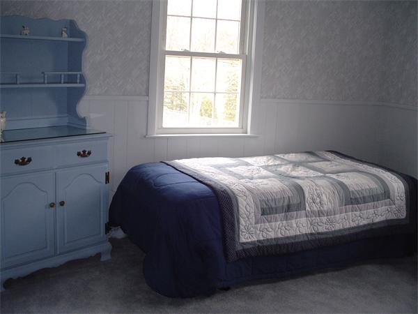 195 North Road Chelmsford, MA 01824 - Photo 13 of 17 a bed sitting in a bedroom next to a window