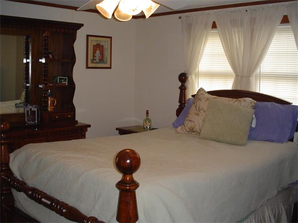 195 North Road Chelmsford, MA 01824 - Photo 9 of 17 a bedroom with a bed and a chandelier