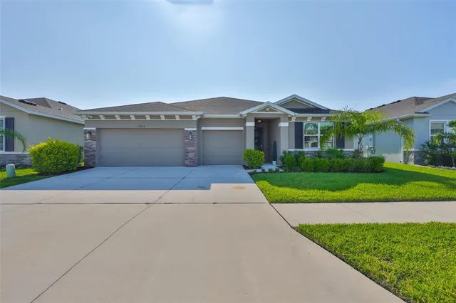 a front view of a house with a yard and garage