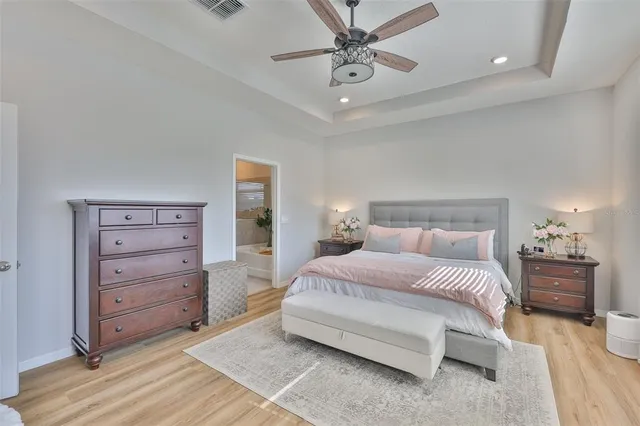 a bedroom with a bed and a chandelier