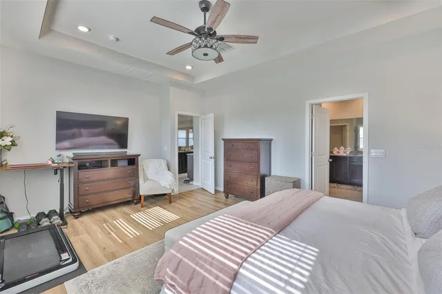 a bedroom with a bed and a chandelier