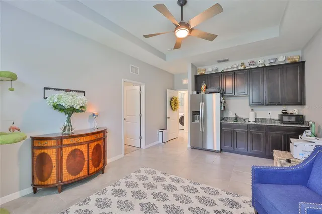 a living room with stainless steel appliances kitchen island granite countertop furniture and a livingroom