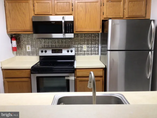 a kitchen with a refrigerator stove and microwave
