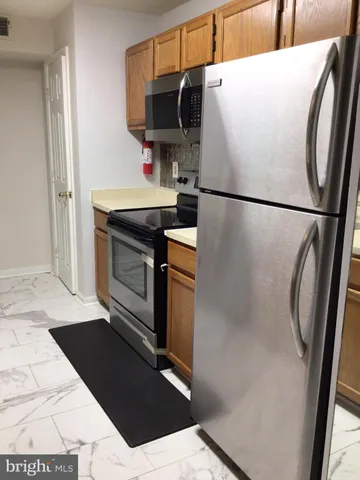 a view of empty room with wooden floor and fireplace
