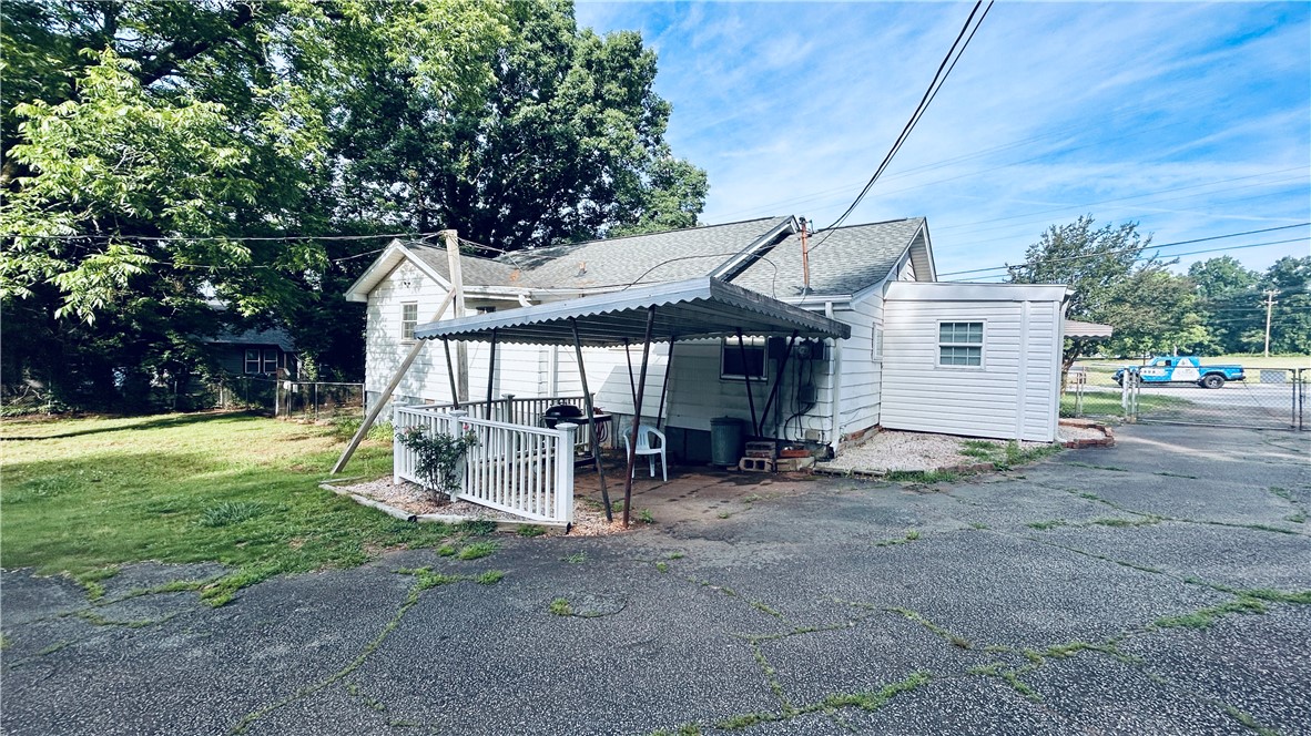 608 29 N Bypass Anderson, SC 29621 - Photo 7 of 20 A quaint backyard patio offers shaded outdoor relaxation and direct home access.