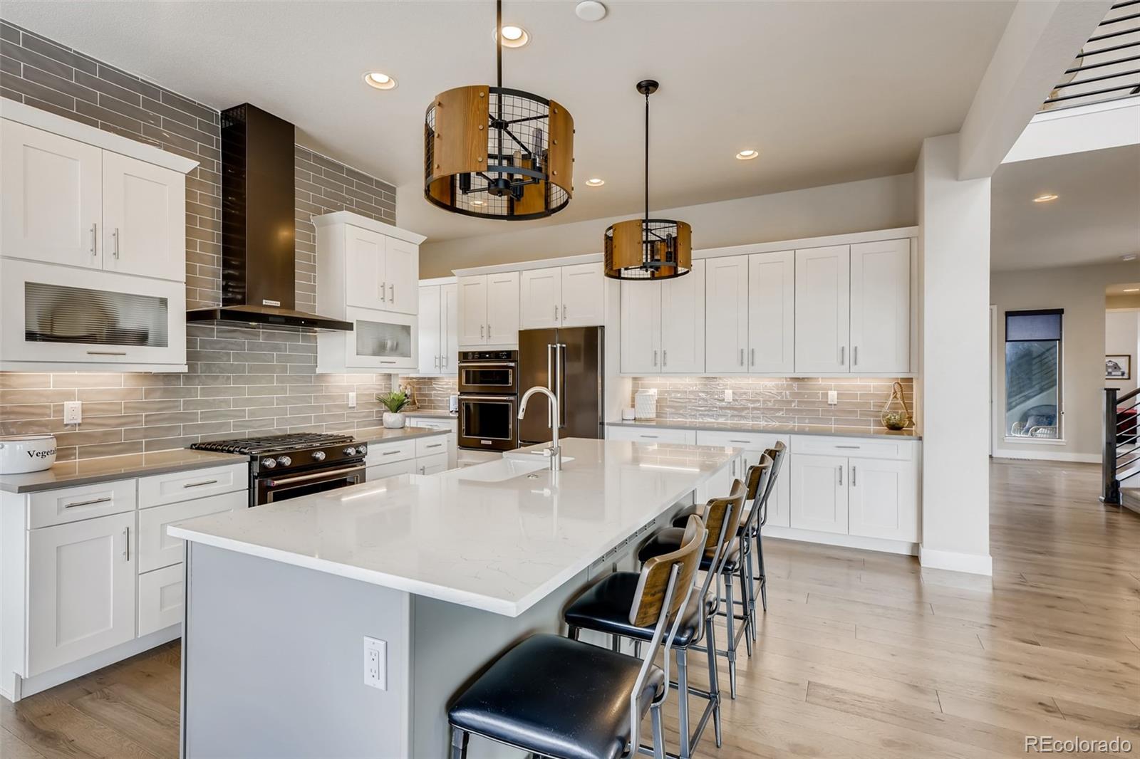 501 Meadowleaf Lane Highlands Ranch, CO 80126 - Photo 8 of 40 a kitchen with a table chairs microwave and cabinets
