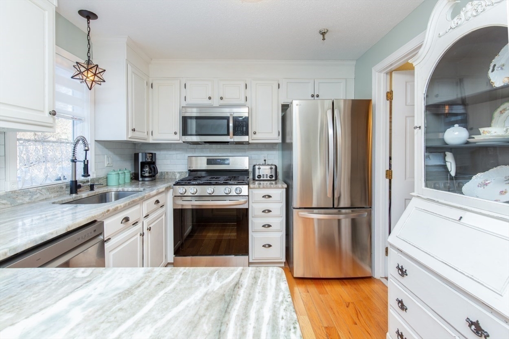 a kitchen with stainless steel appliances a refrigerator stove and microwave