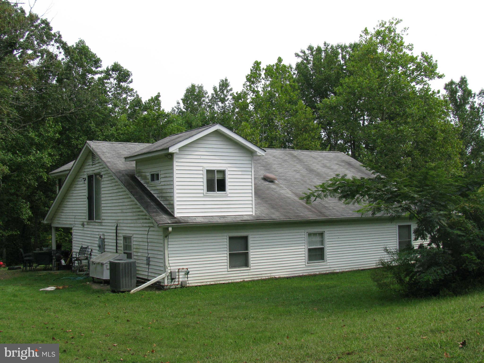 10337 Fairview Road Bumpass, VA 23024 - Photo 4 of 18 a front view of a house with a yard and trees