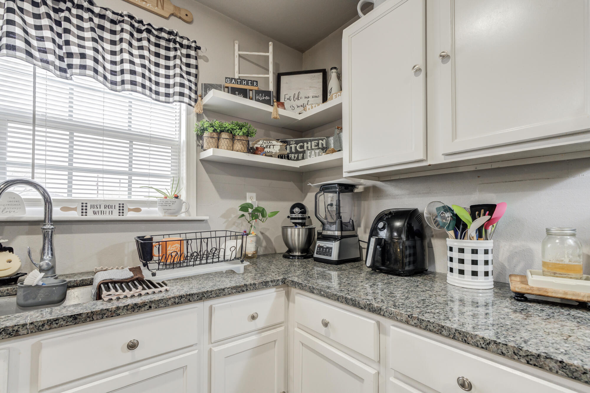 1515 36th Street Lubbock, TX 79412 - Photo 11 of 23 a kitchen with stainless steel appliances granite countertop a sink and cabinets