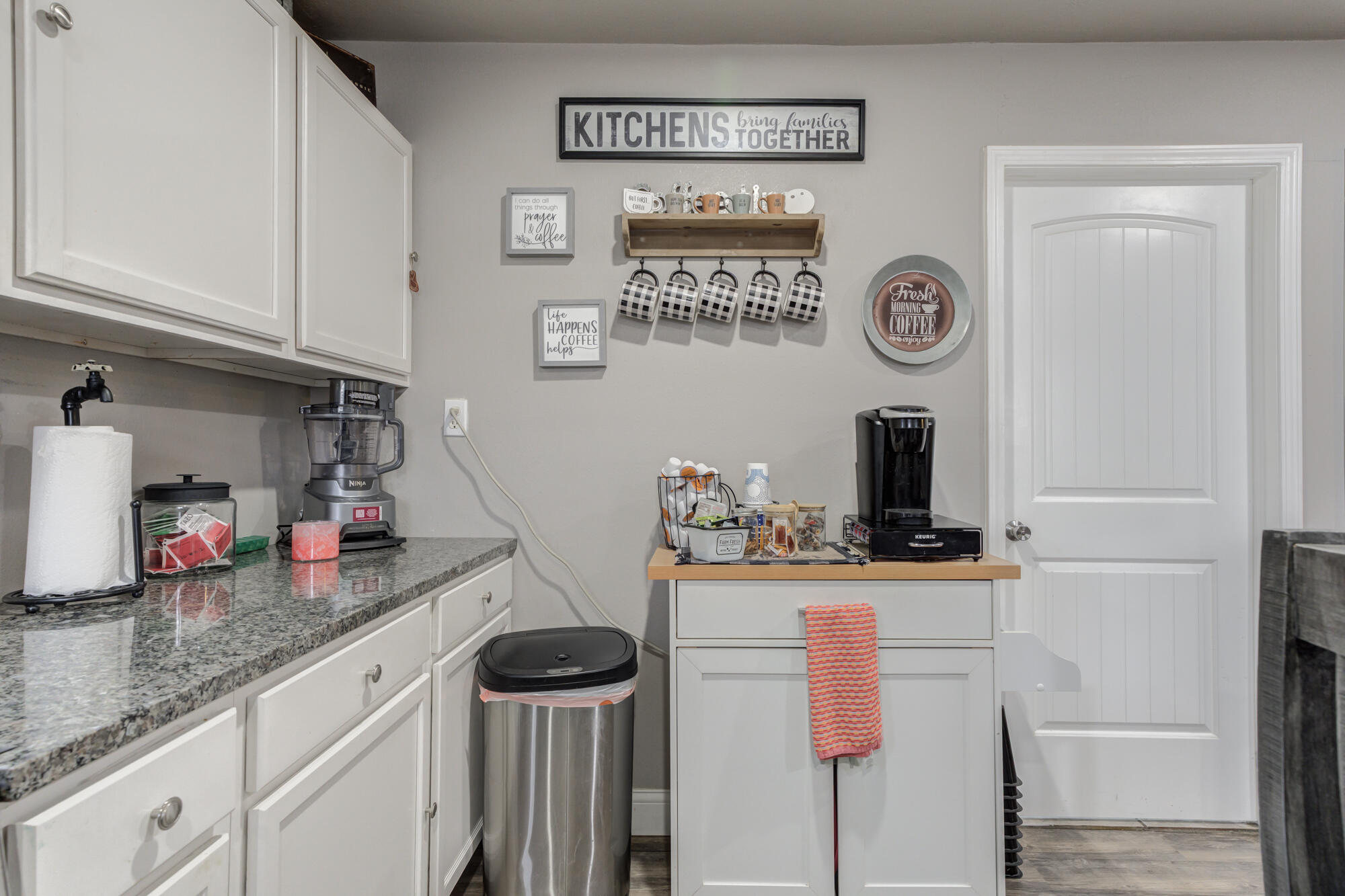 1515 36th Street Lubbock, TX 79412 - Photo 12 of 23 a kitchen with granite countertop cabinets a stove and a refrigerator