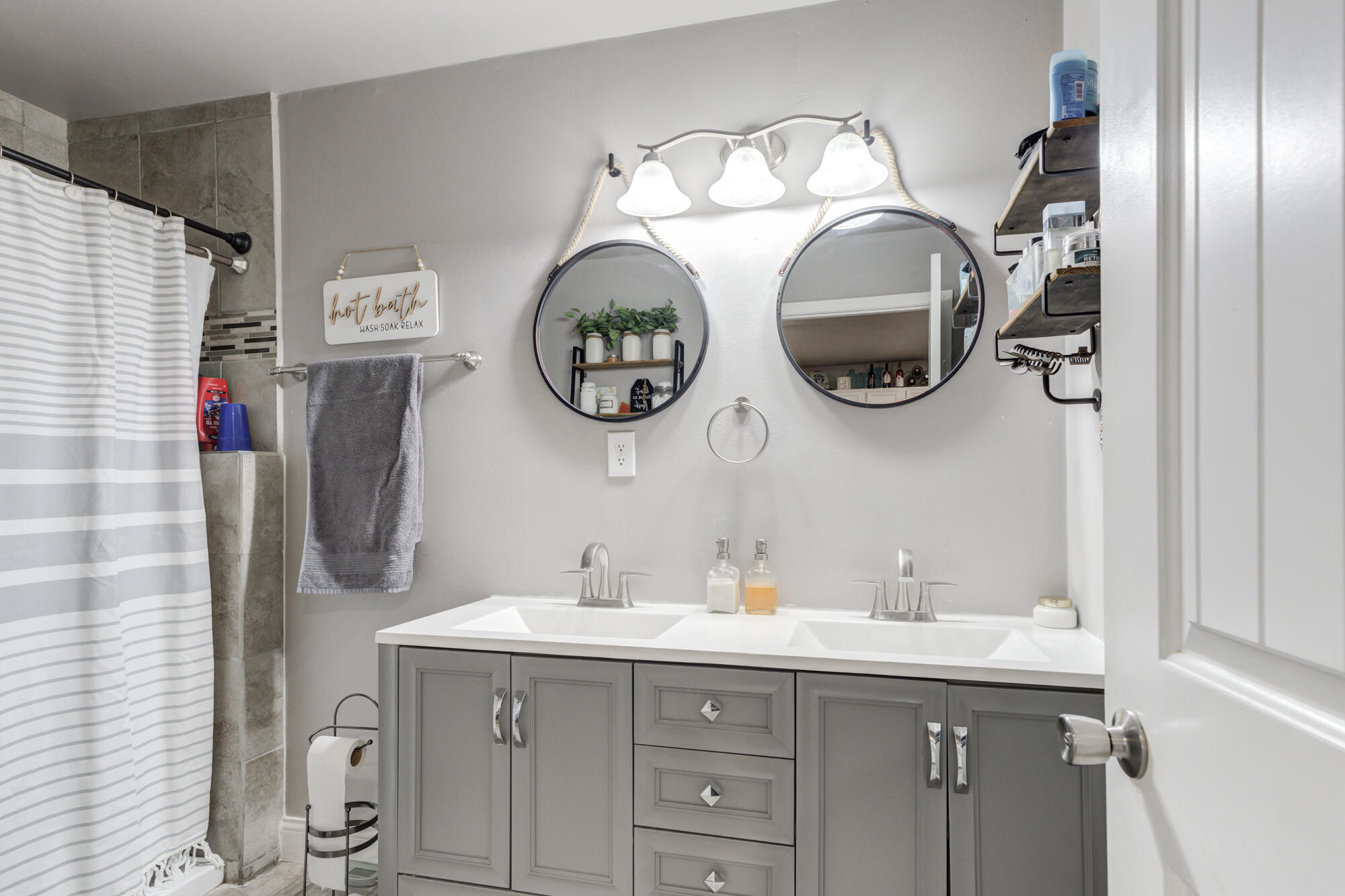 1515 36th Street Lubbock, TX 79412 - Photo 13 of 23 a bathroom with a sink and a mirror
