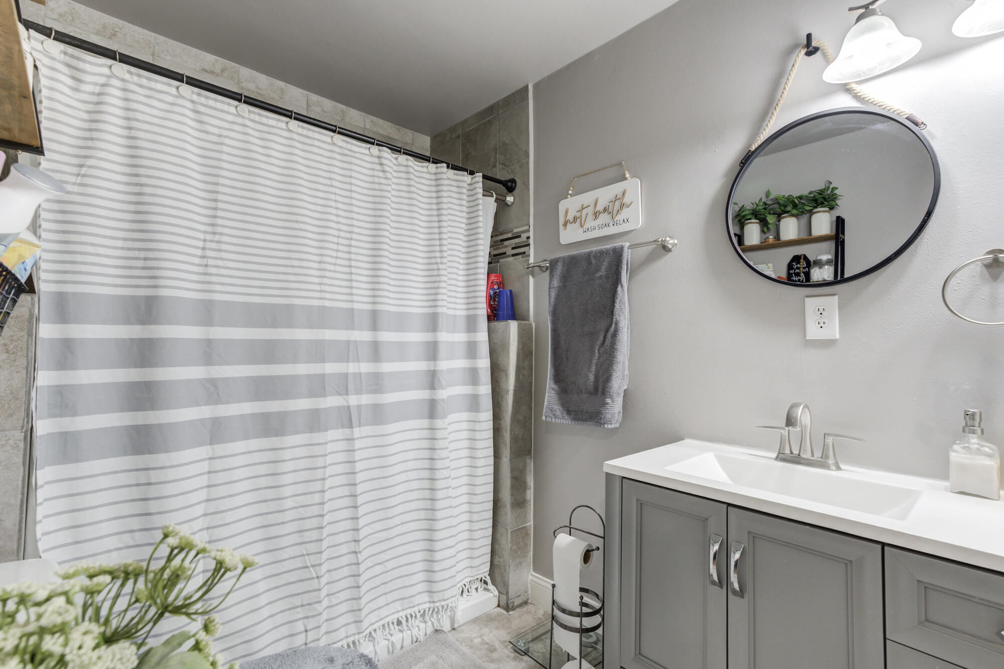 1515 36th Street Lubbock, TX 79412 - Photo 14 of 23 a bathroom with a sink and a mirror