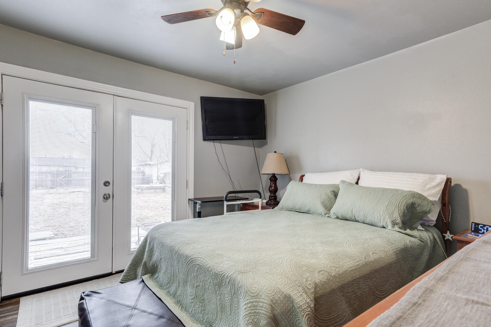 1515 36th Street Lubbock, TX 79412 - Photo 15 of 23 a large bed sitting in a bedroom next to a window and a flat screen tv