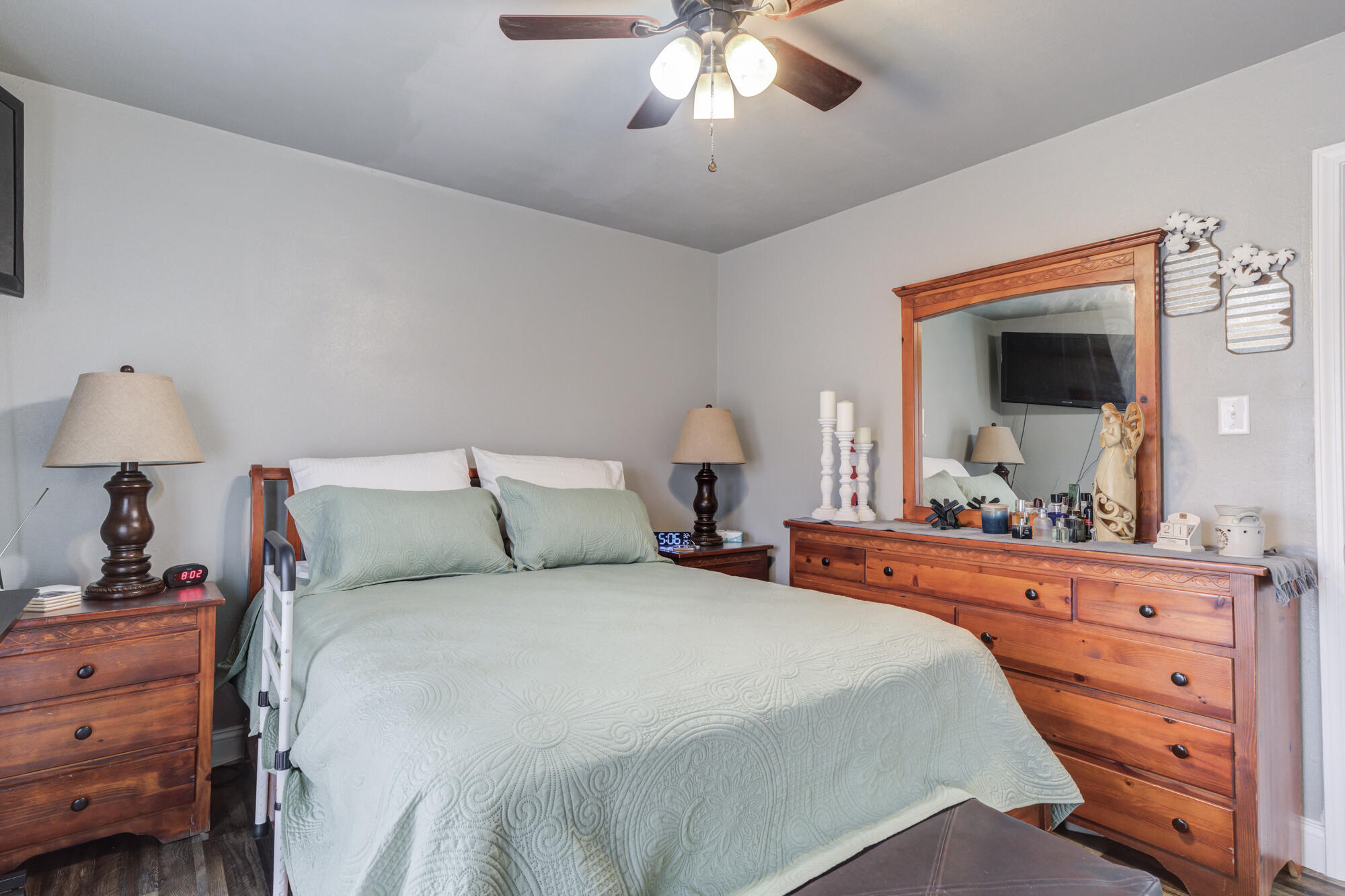 1515 36th Street Lubbock, TX 79412 - Photo 16 of 23 a bedroom with a bed and a chandelier
