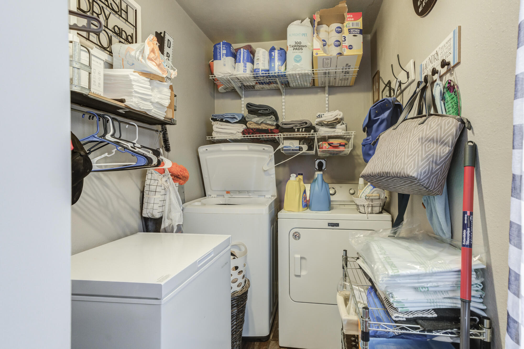 1515 36th Street Lubbock, TX 79412 - Photo 18 of 23 a utility room with dryer washer and a wooden floor