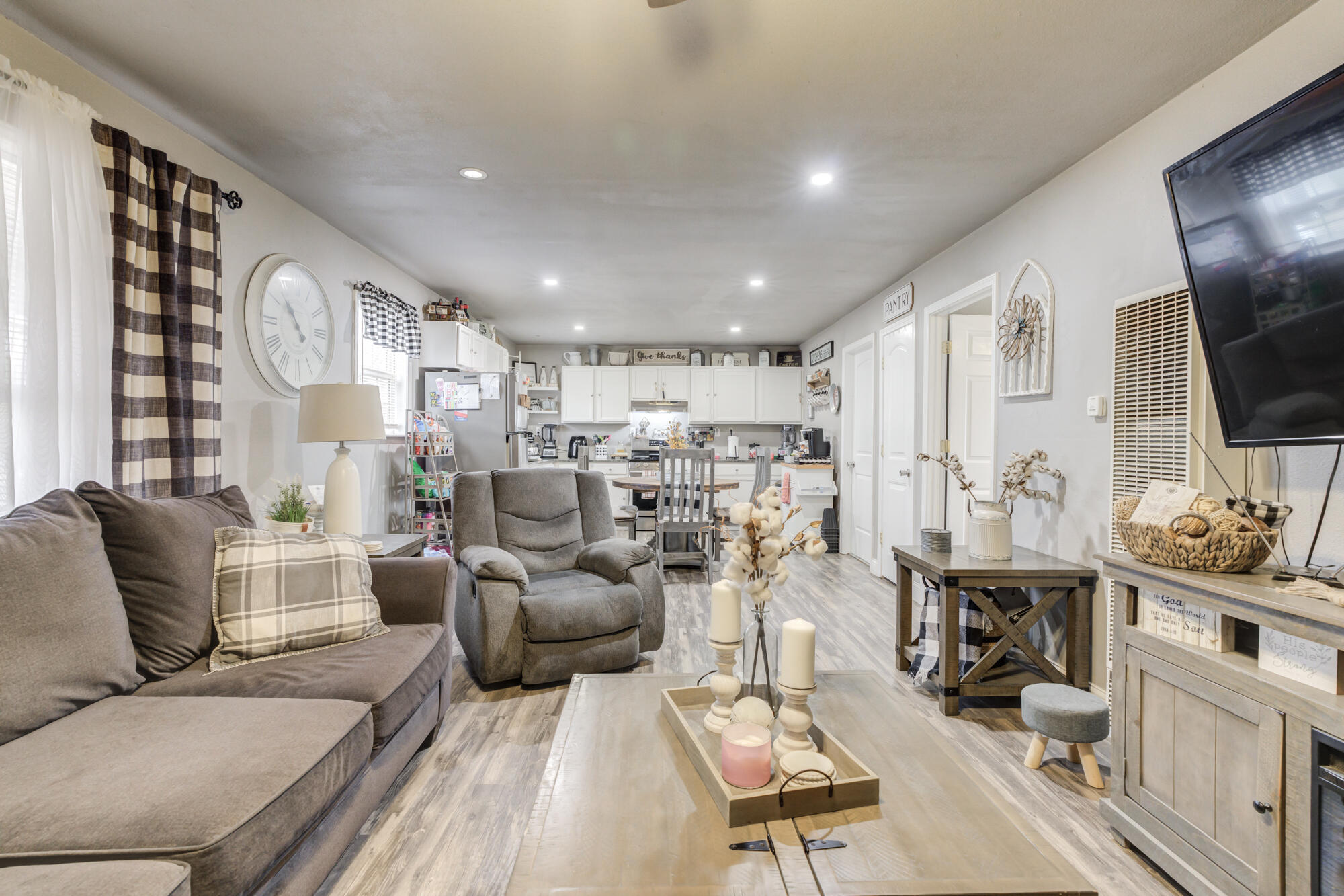 1515 36th Street Lubbock, TX 79412 - Photo 3 of 23 a living room with furniture kitchen view and a flat screen tv
