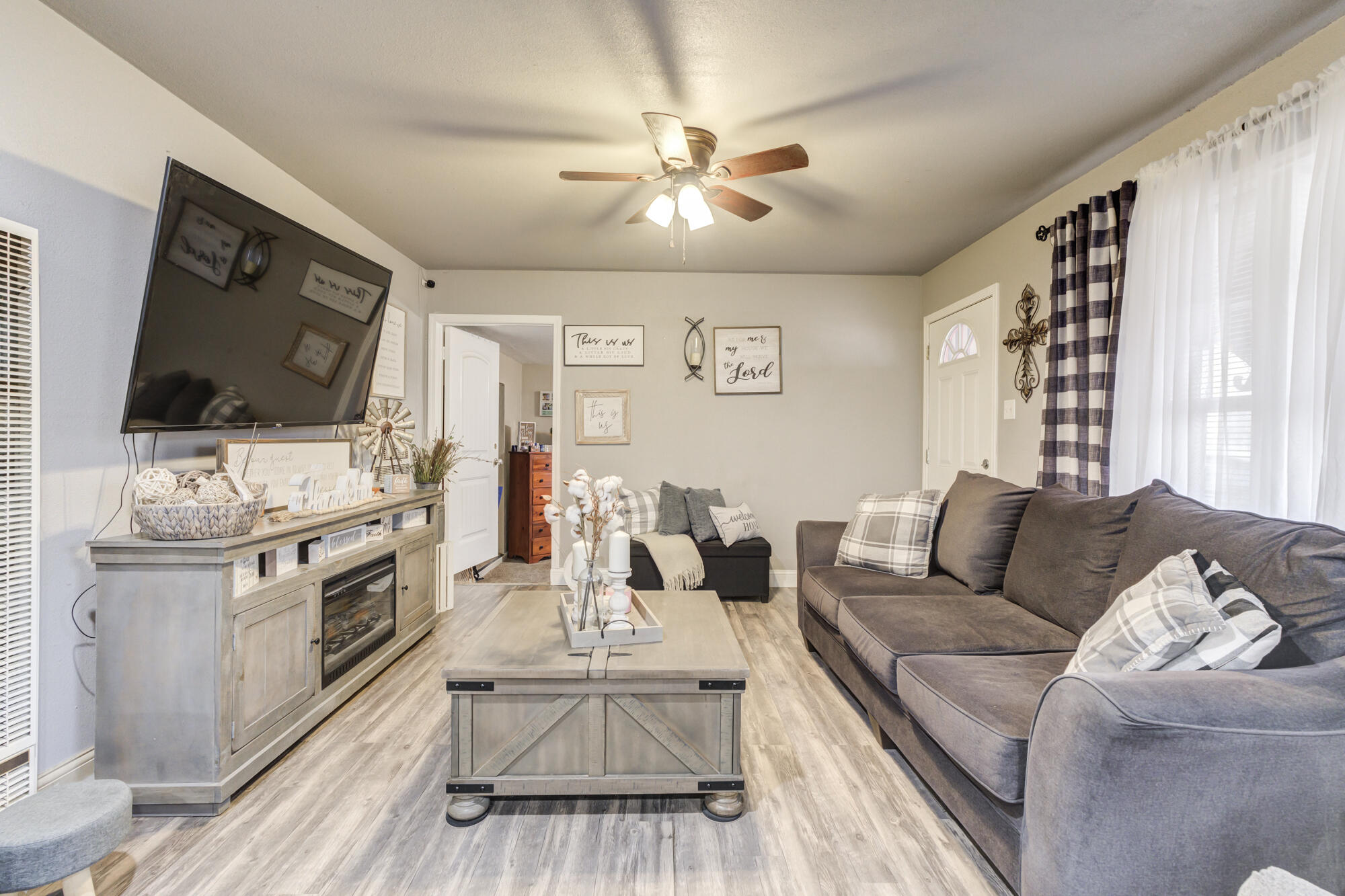 1515 36th Street Lubbock, TX 79412 - Photo 5 of 23 a living room with furniture and a flat screen tv