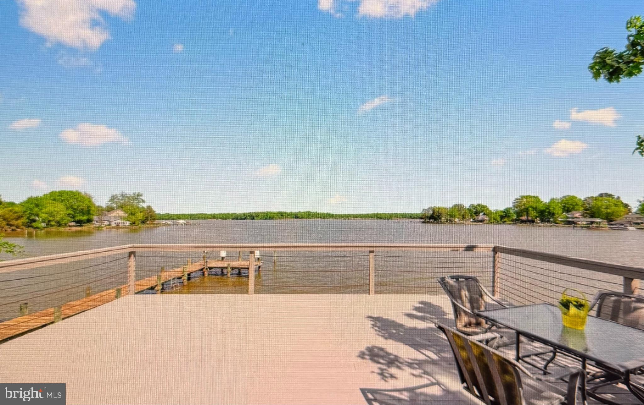 a view of a terrace with outdoor seating and lake view