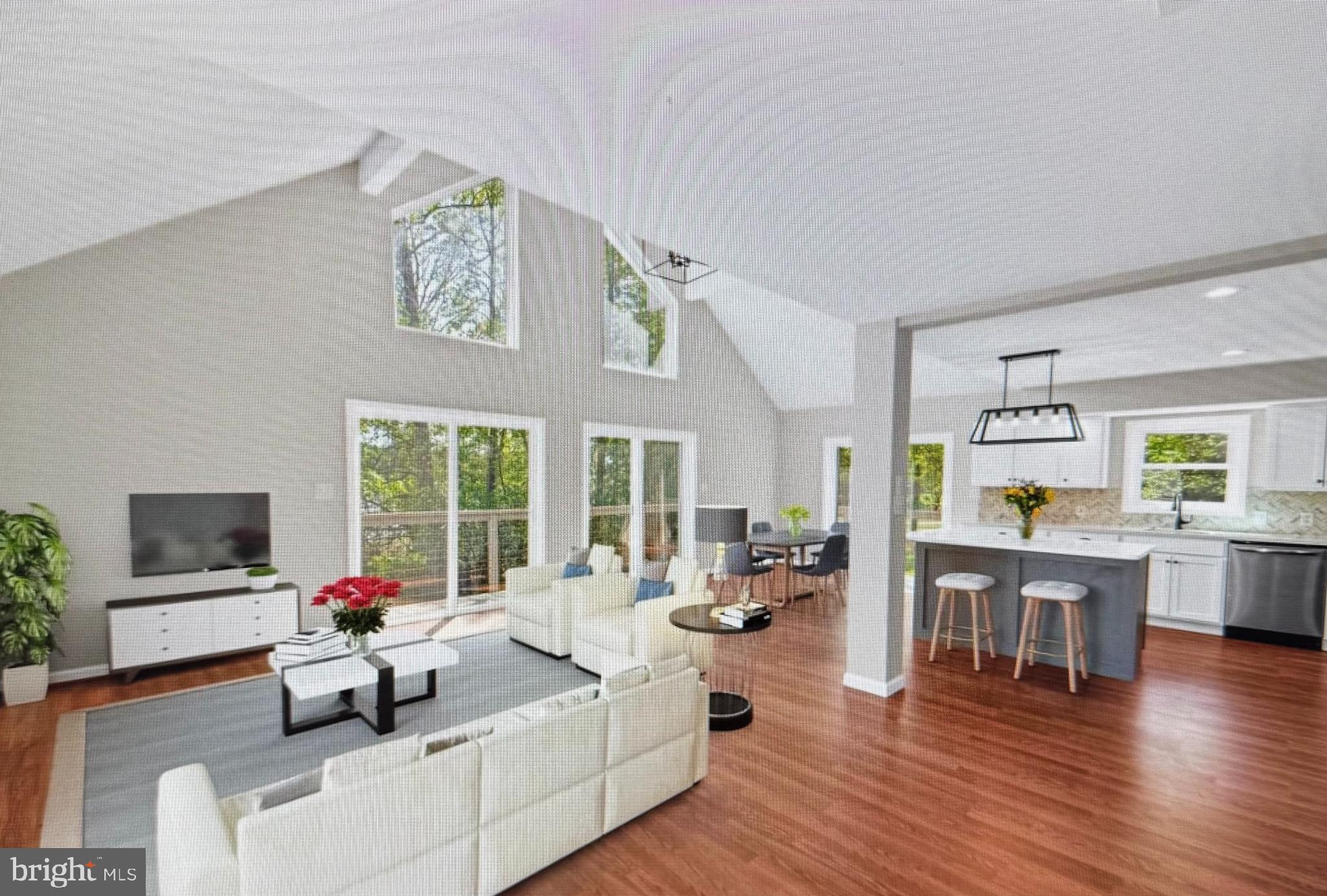 6812 Schaadts Road, Unit 6812 Middle River, MD 21220 - Photo 2 of 5 a living room with furniture flat screen tv and wooden floor