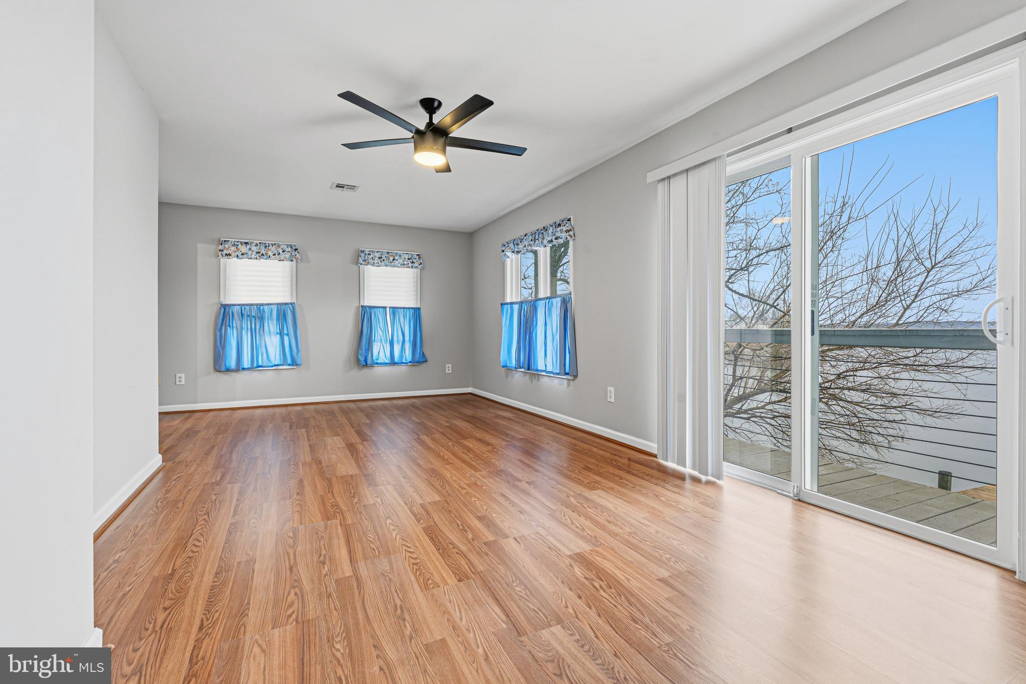 6812 Schaadts Road, Unit 6812 Middle River, MD 21220 - Photo 27 of 54 a view of an empty room with a window and wooden floor